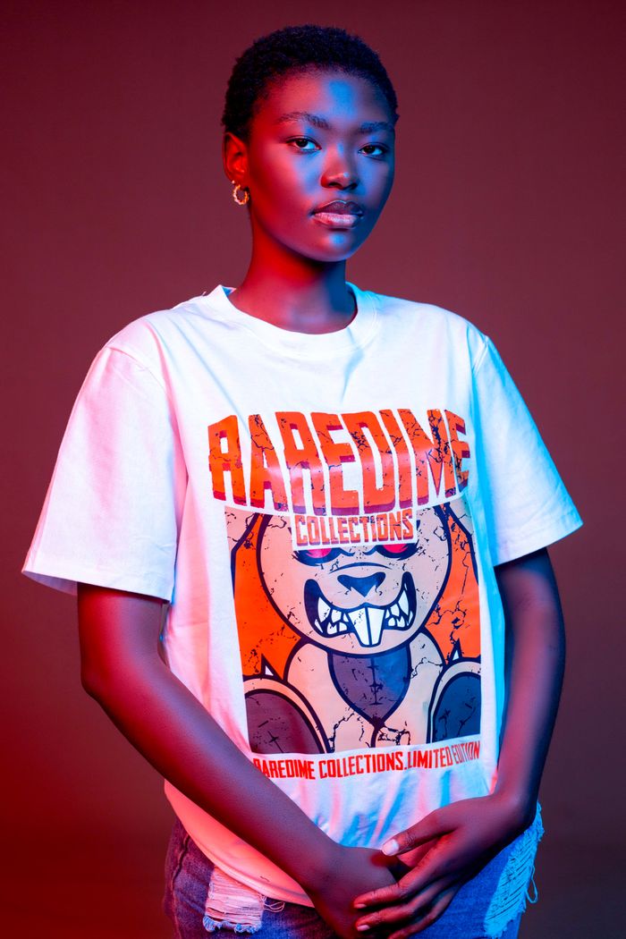 Dynamic fashion shoot featuring a model in a bold graphic tee, Gaborone studio setting.